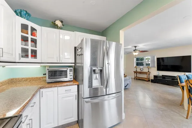 a kitchen with stainless steel appliances granite countertop a refrigerator and a stove top oven