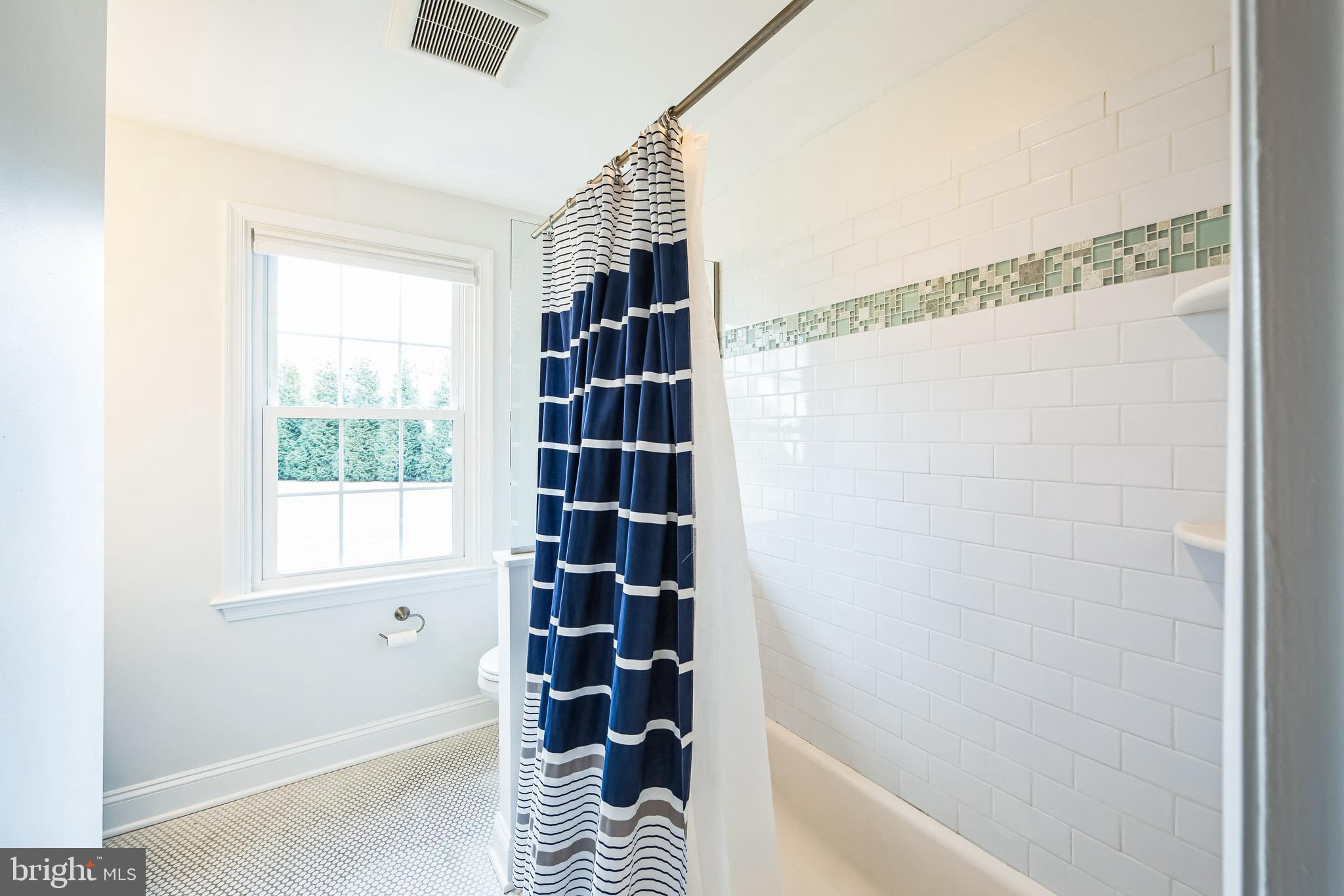 131 Clover Hill Lane Wayne, PA 19087 - Photo 27 of 50 a bathroom with a shower and a window