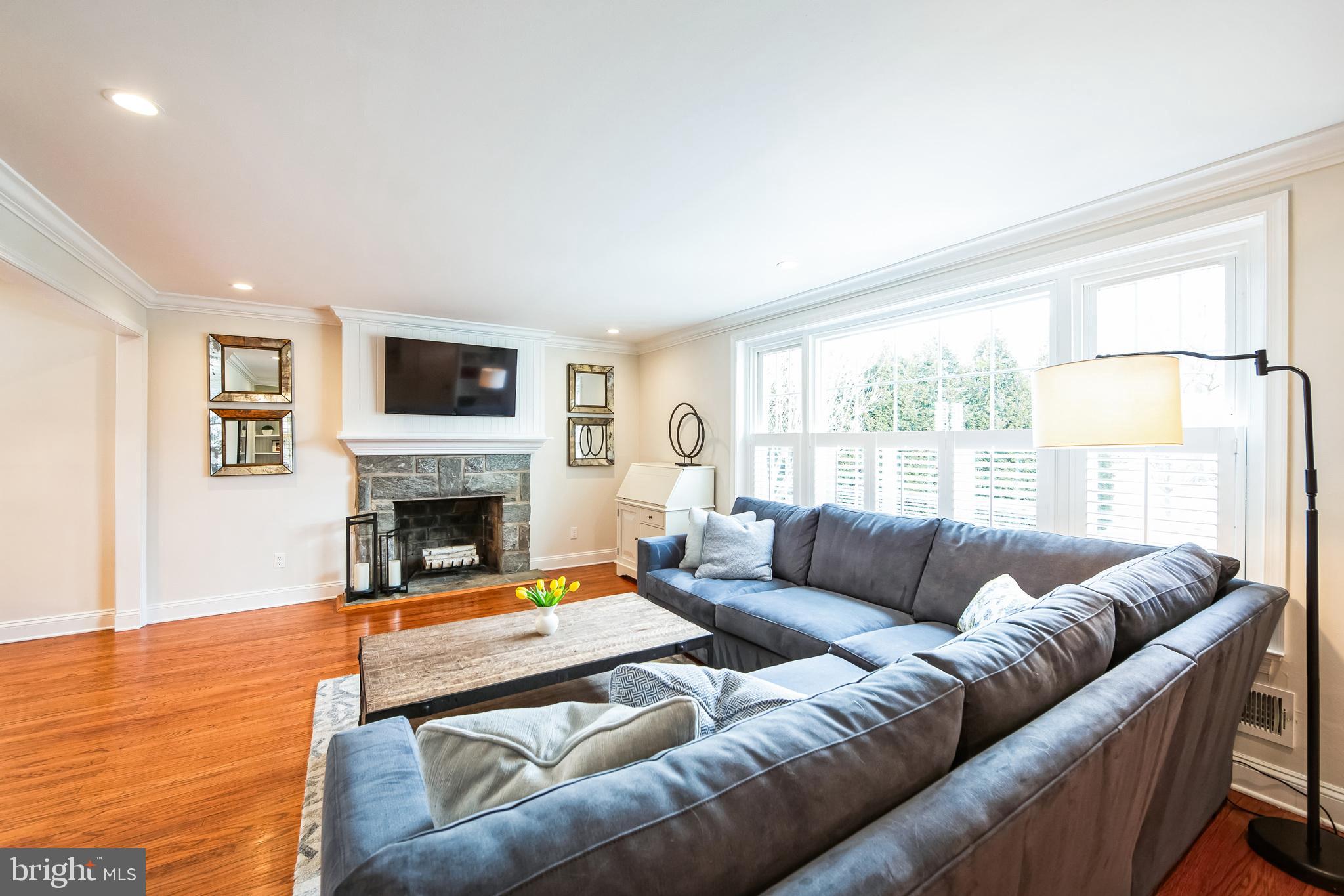 131 Clover Hill Lane Wayne, PA 19087 - Photo 3 of 50 a living room with furniture a fireplace and a flat screen tv