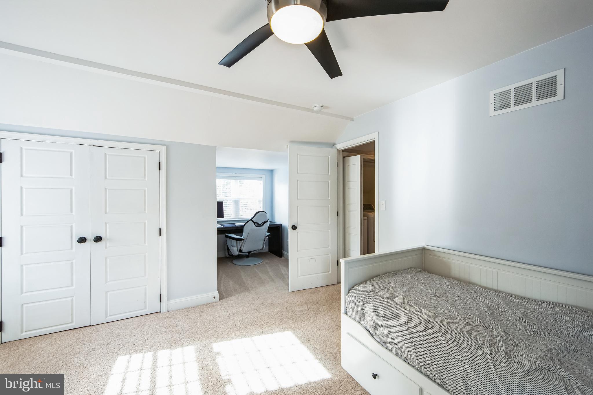 131 Clover Hill Lane Wayne, PA 19087 - Photo 31 of 50 a bedroom with a bed and a chandelier