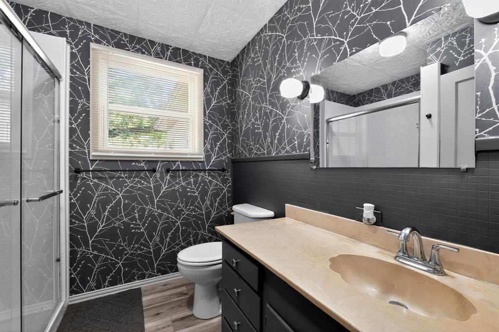 5485 Highway 7 Marlin, TX 76661 - Photo 9 of 36 Bathroom featuring wallpapered walls, light wood-type flooring, an ornate ceiling, vanity, and a stall shower