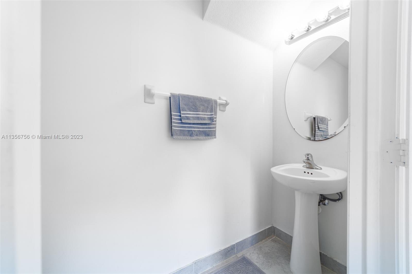 11444 Southwest 251st Street Homestead, FL 33032 - Photo 11 of 40 a bathroom with a sink a mirror and shower