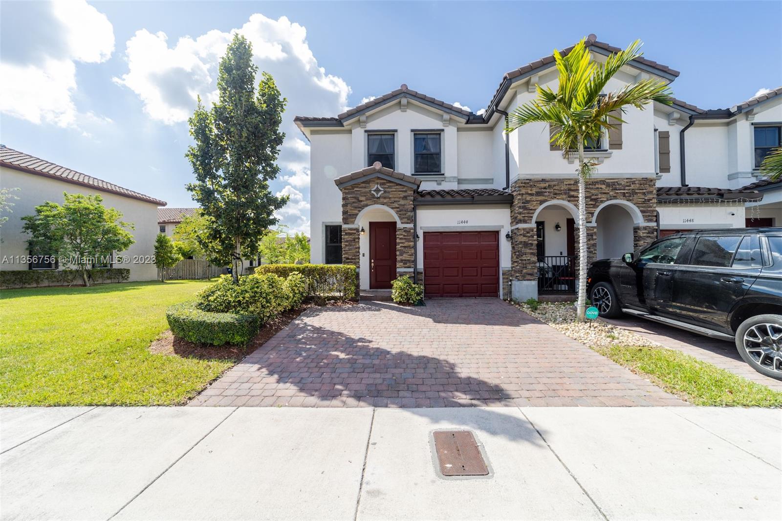11444 Southwest 251st Street Homestead, FL 33032 - Photo 2 of 40 a front view of a house with garden