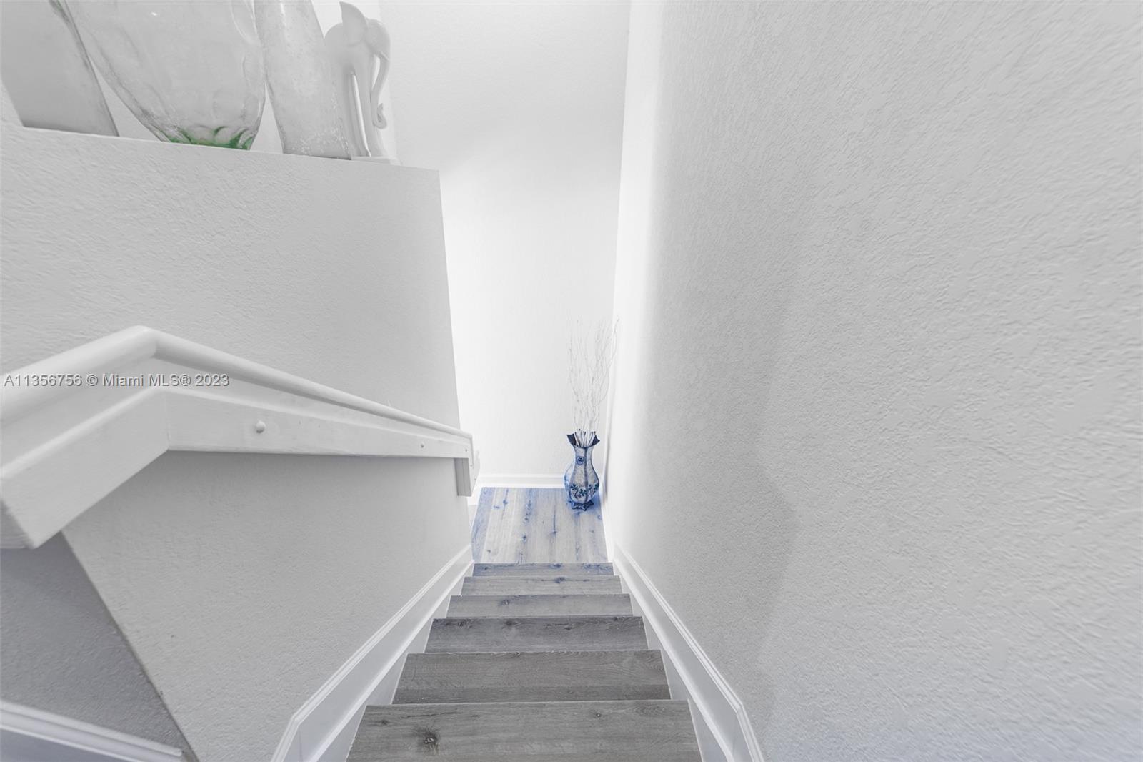 11444 Southwest 251st Street Homestead, FL 33032 - Photo 21 of 40 a view of a hallway with wooden floor and a white wall