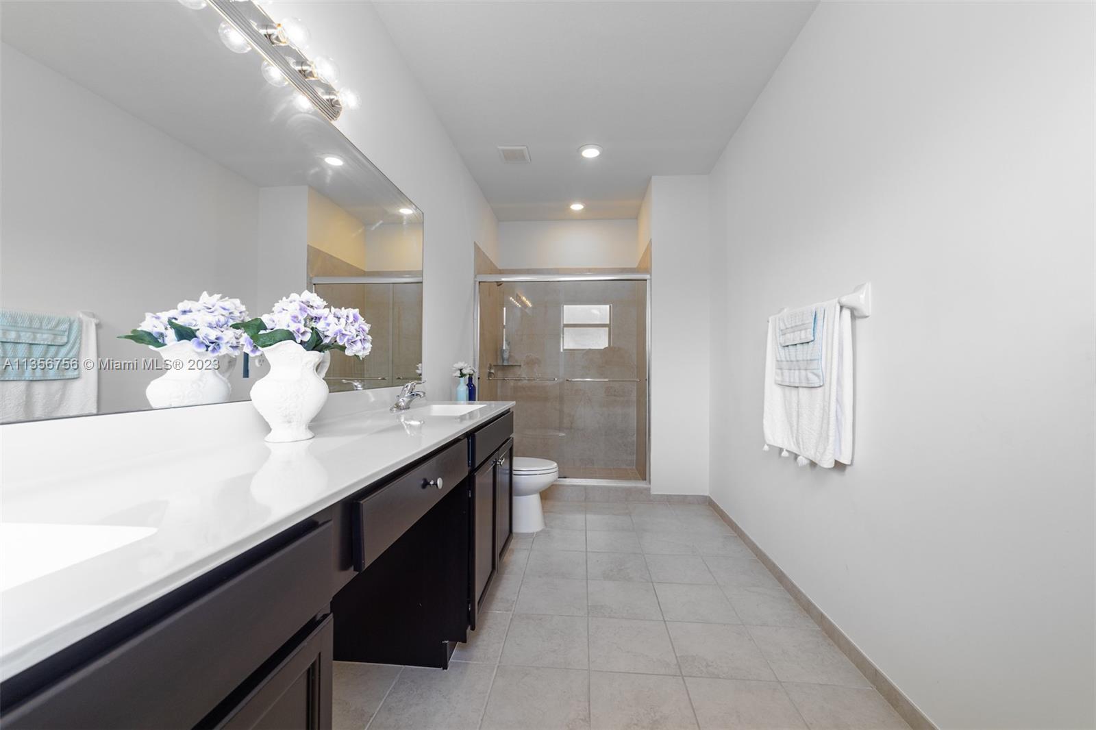 11444 Southwest 251st Street Homestead, FL 33032 - Photo 25 of 40 a hallway with mirror and chandelier
