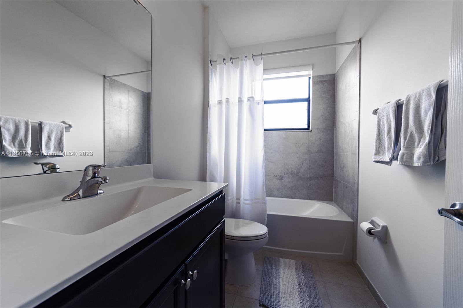 11444 Southwest 251st Street Homestead, FL 33032 - Photo 29 of 40 a bathroom with a sink a toilet and shower