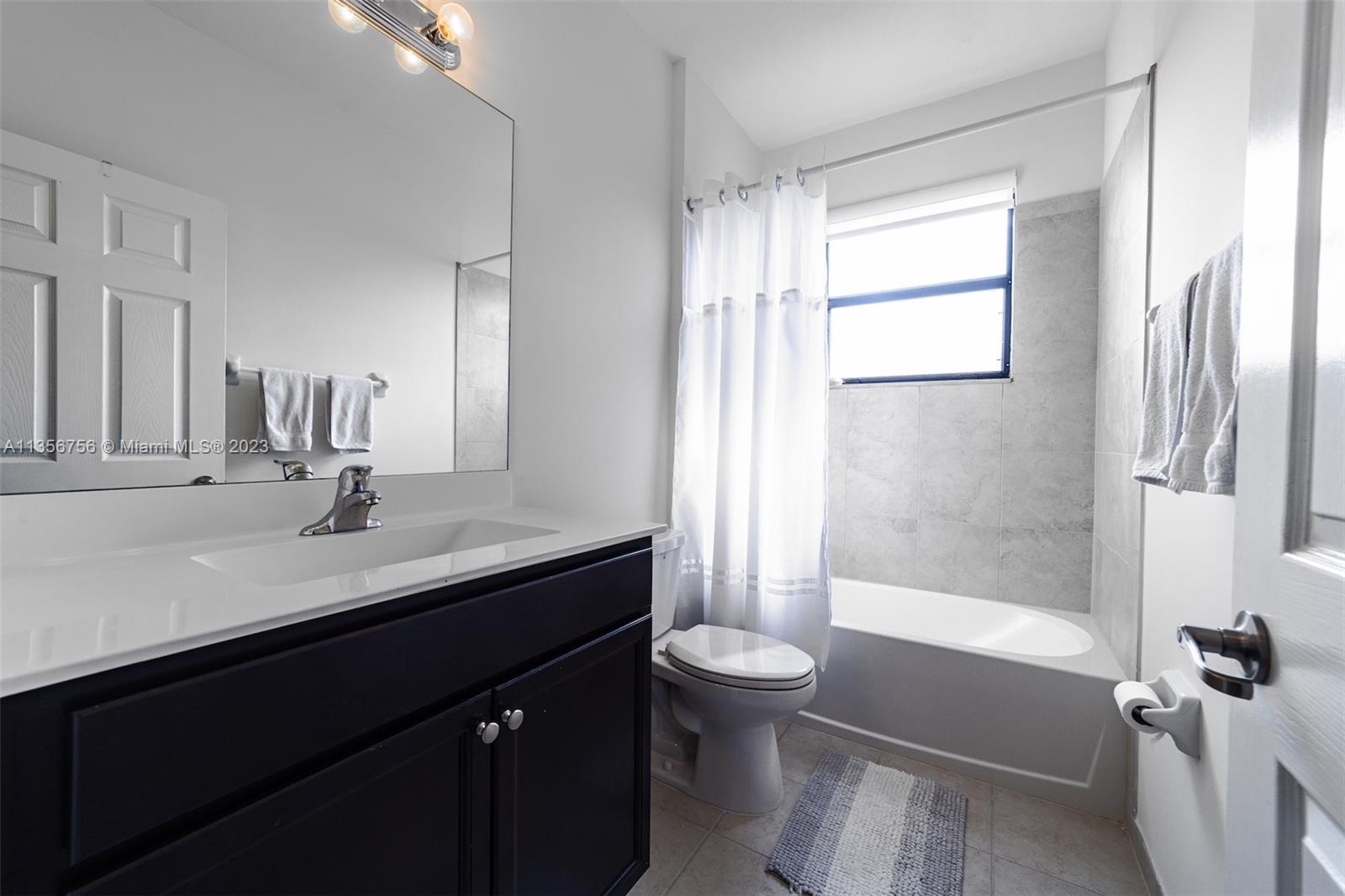 11444 Southwest 251st Street Homestead, FL 33032 - Photo 30 of 40 a bathroom with a sink a toilet and shower