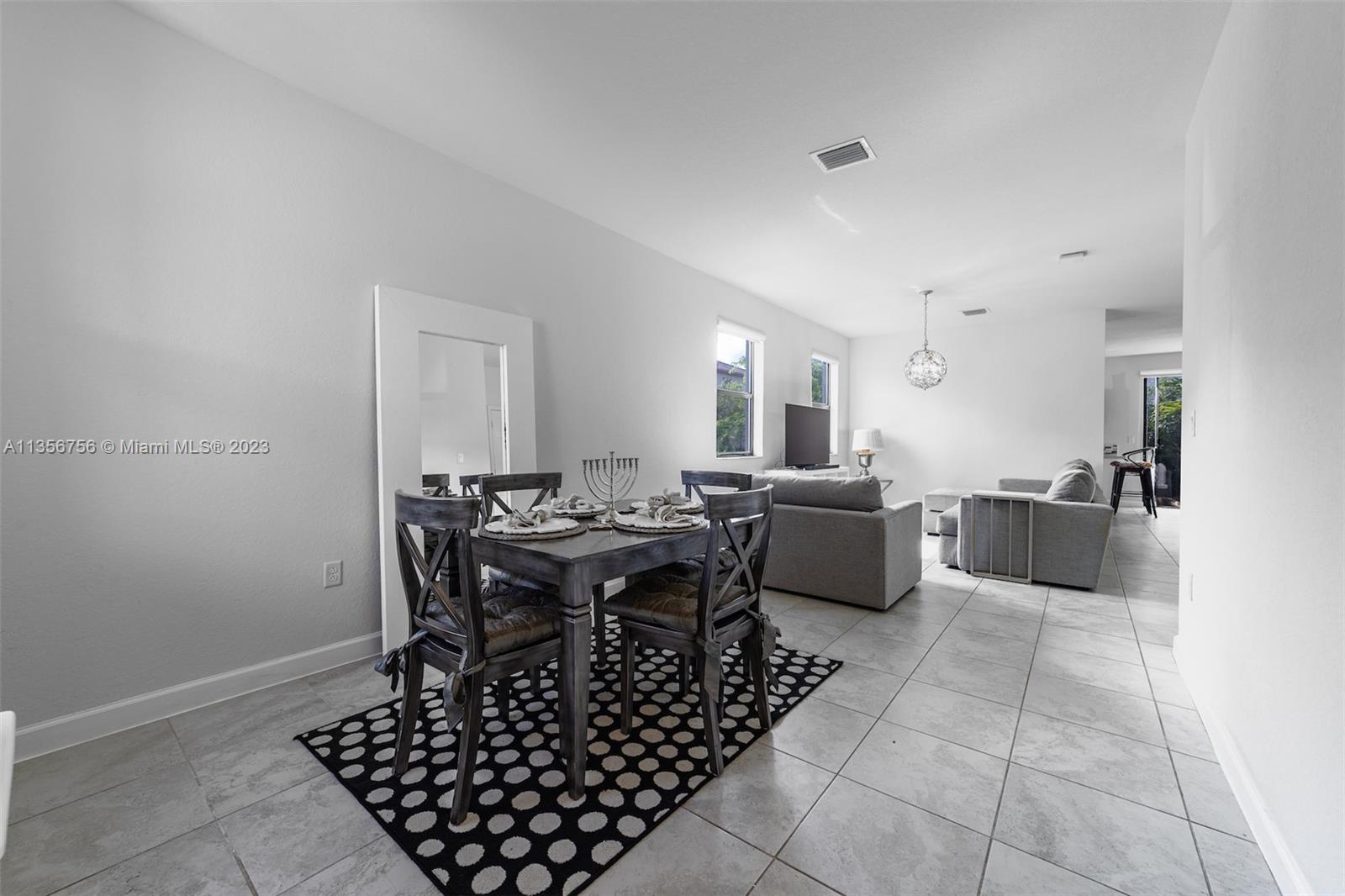11444 Southwest 251st Street Homestead, FL 33032 - Photo 7 of 40 a large kitchen with a table and chairs