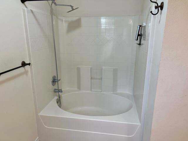 306 Shield Drive Crestview, FL 32539 - Photo 13 of 16 a white bath tub sitting next to a shower