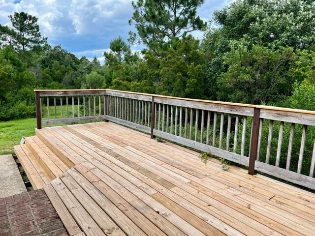 306 Shield Drive Crestview, FL 32539 - Photo 16 of 16 a balcony with wooden floor and fence