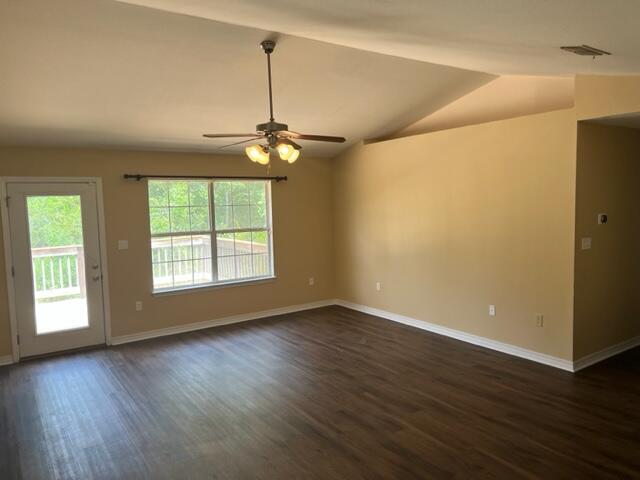 306 Shield Drive Crestview, FL 32539 - Photo 6 of 16 an empty room with wooden floor fan and windows