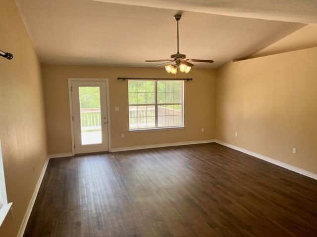 306 Shield Drive Crestview, FL 32539 - Photo 7 of 16 an empty room with wooden floor chandelier and windows