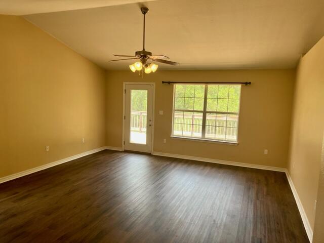 306 Shield Drive Crestview, FL 32539 - Photo 8 of 16 a view of an empty room with wooden floor and a window
