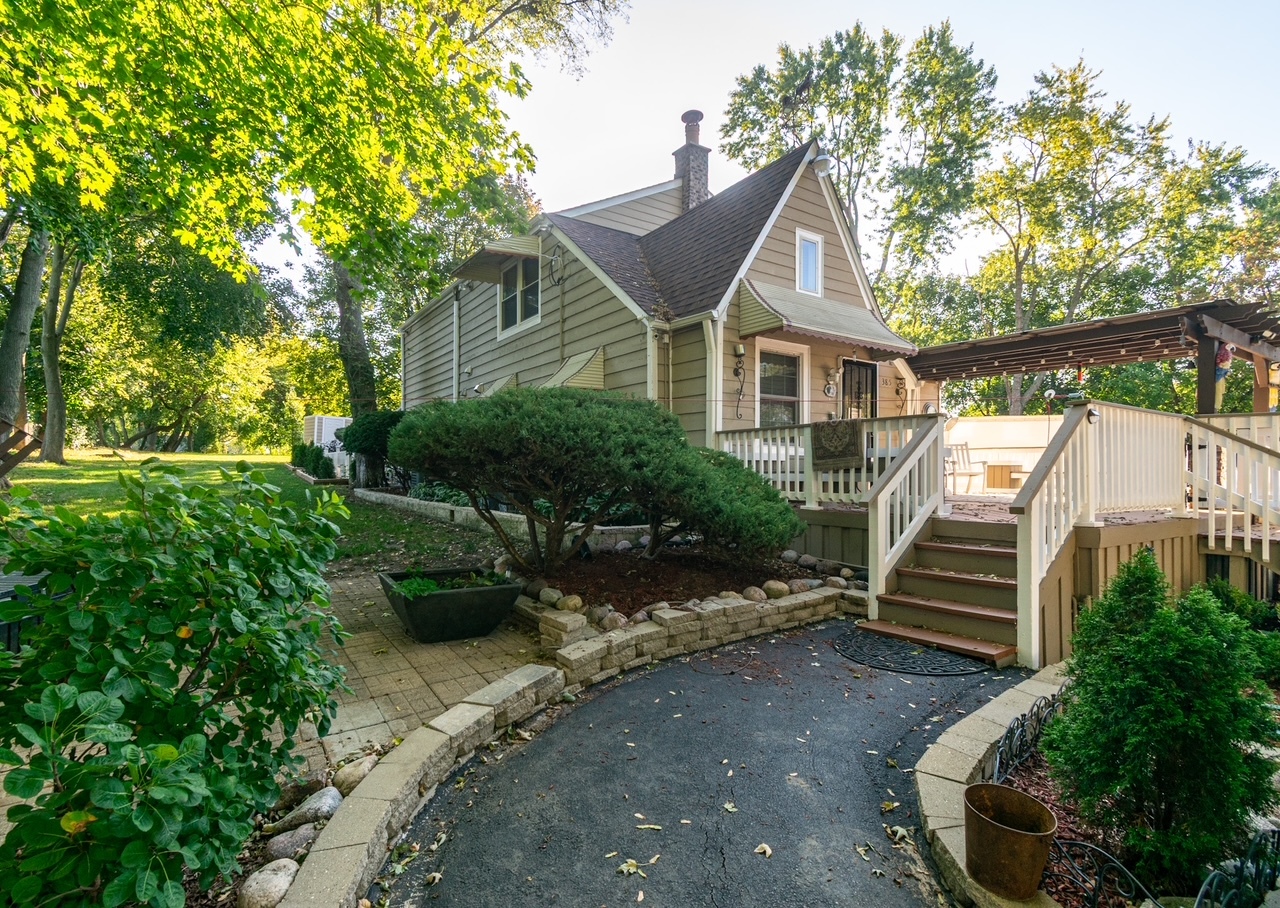385 East Irving Park Road Streamwood, IL 60107 - Photo 1 of 1 a front view of a house with a yard
