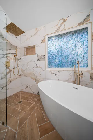 a bathroom with a bathtub and a shower