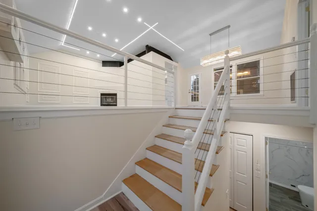 a view of entryway with wooden floor and white walls