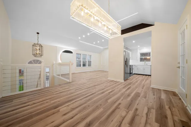 a view of empty room with wooden floor