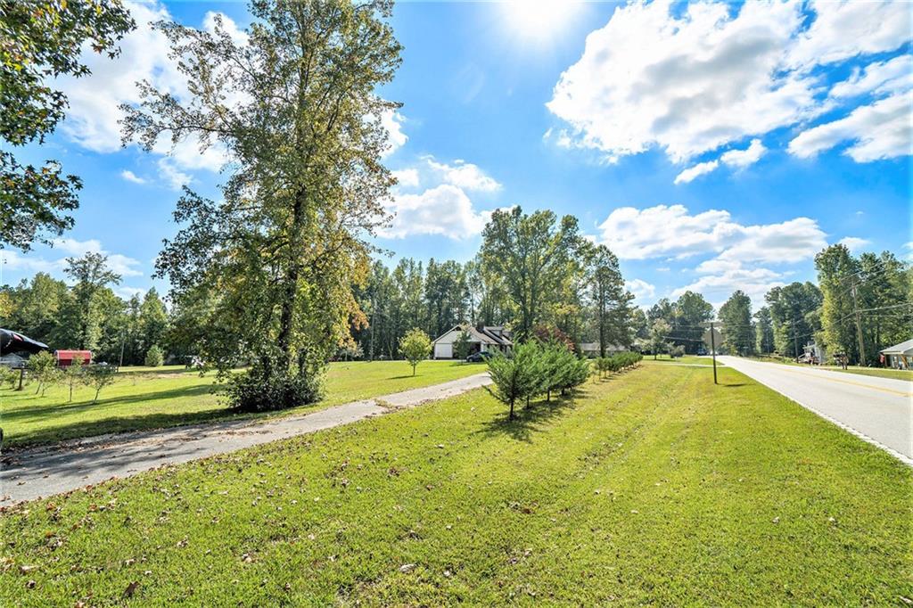 1736 Pleasant Grove Road Temple, GA 30179 - Photo 30 of 31 a view of a swimming pool with a yard and a large tree