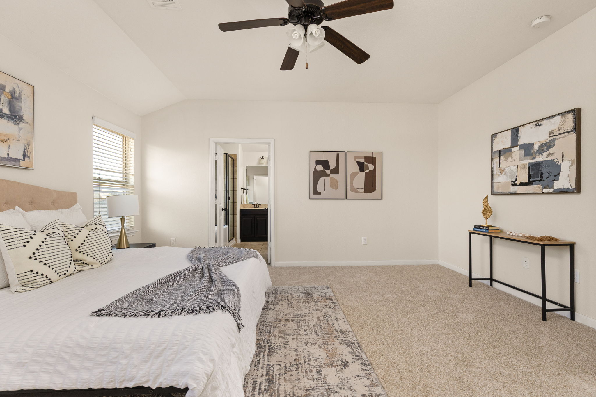 2400 Leonards Pass Leander, TX 78641 - Photo 27 of 40 Comfortable carpeting and a ceiling fan create a serene primary bedroom retreat.