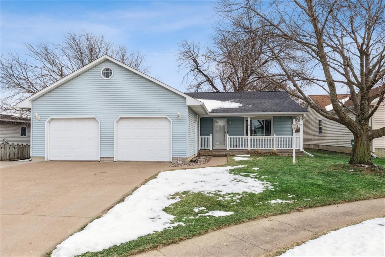 1045 Sweet Briar Lane Clinton, IA 52732 - Photo 1 of 33 a front view of a house with a yard and garage