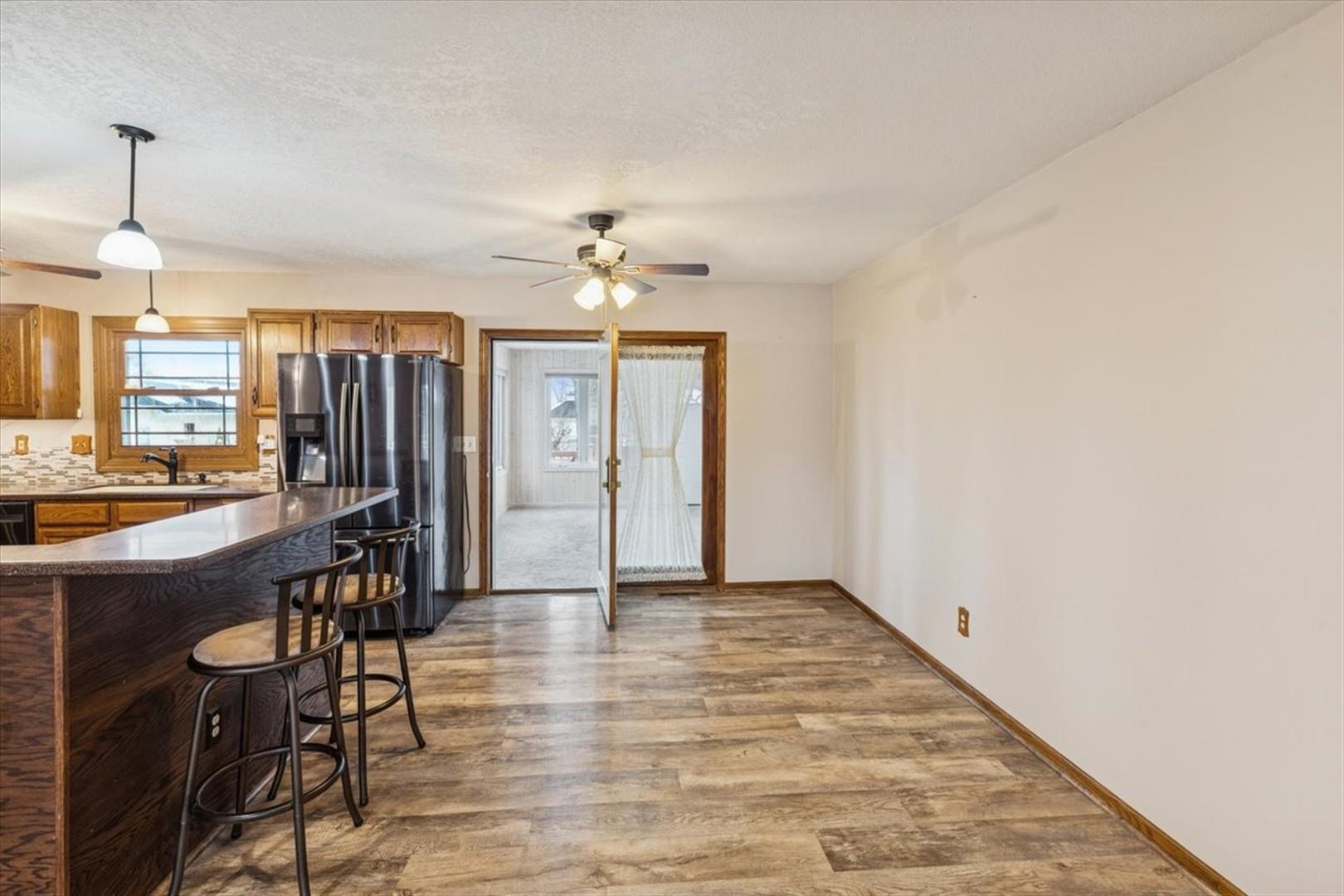 1045 Sweet Briar Lane Clinton, IA 52732 - Photo 15 of 33 an empty room with chandelier fan and windows