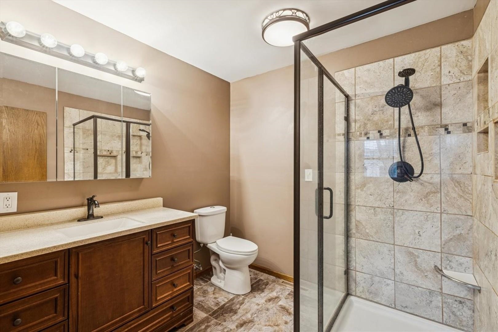 1045 Sweet Briar Lane Clinton, IA 52732 - Photo 21 of 33 a bathroom with a sink a toilet and shower