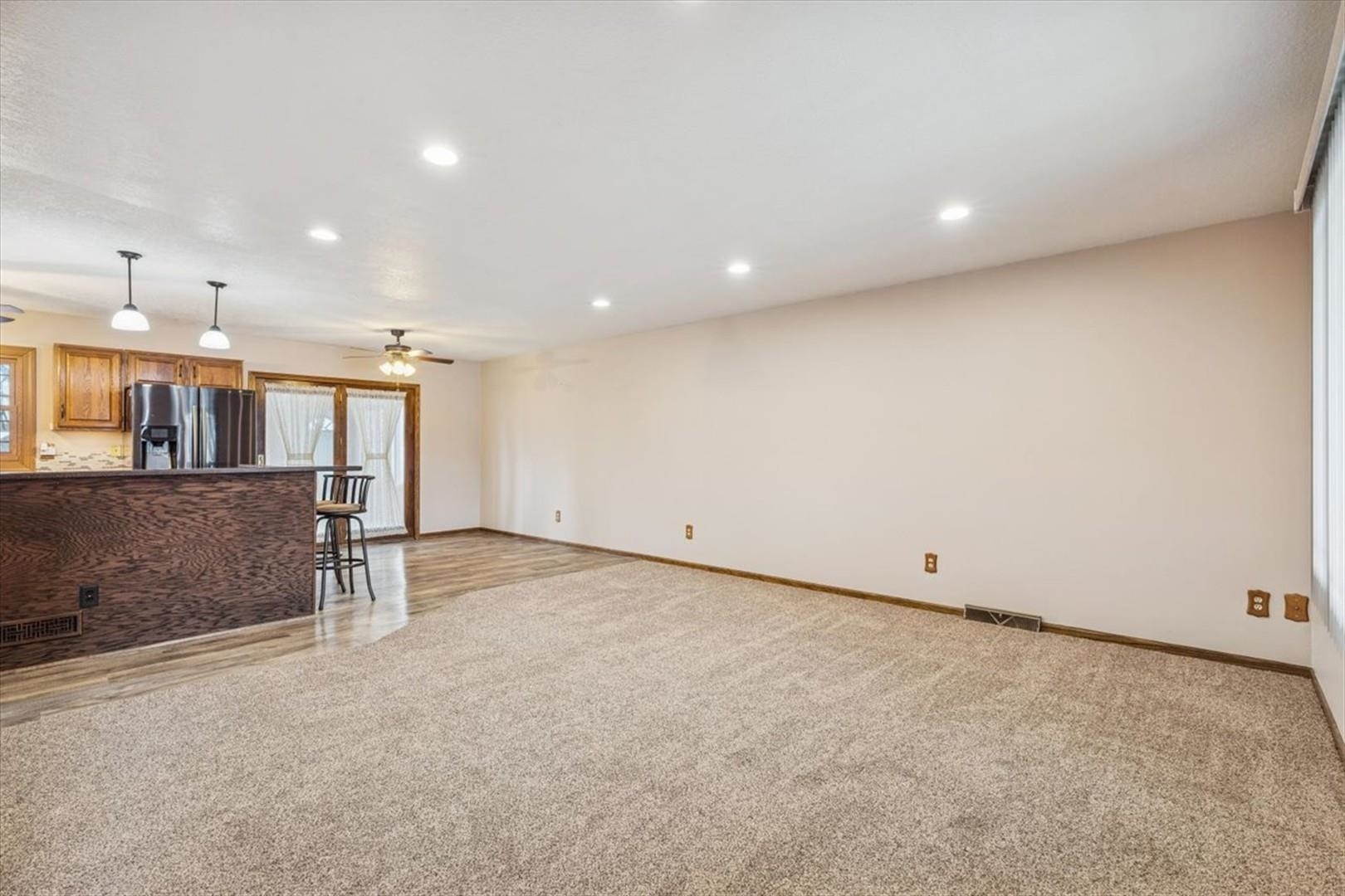 1045 Sweet Briar Lane Clinton, IA 52732 - Photo 8 of 33 an empty room with wooden cabinet and windows