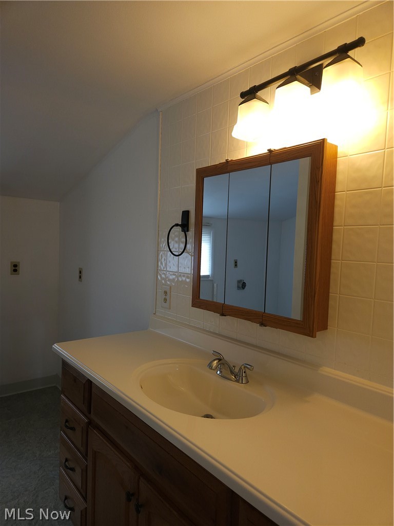 4660 Darrow Road Stow, OH 44224 - Photo 22 of 25 Wood-finish vanity with an integrated sink and countertop in the 2nd floor bathroom
