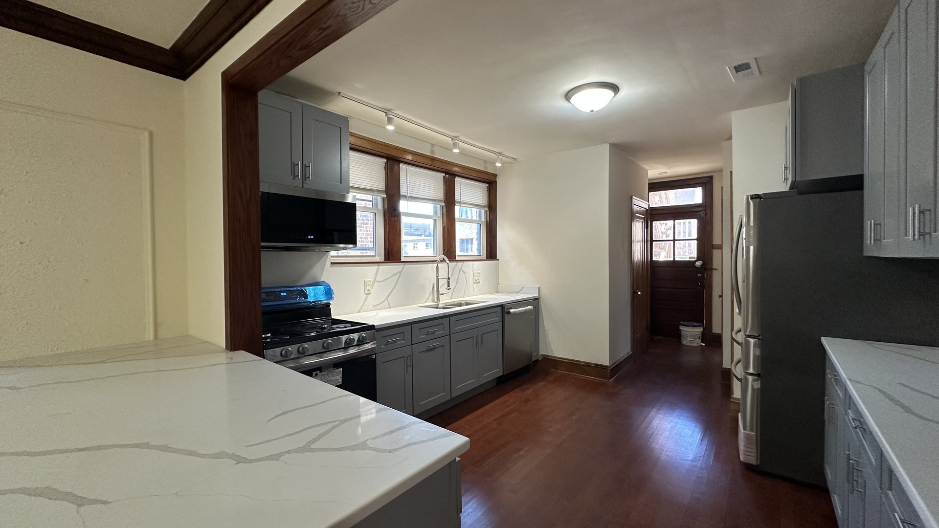 5530 North Artesian Avenue, Unit 3 Chicago, IL 60625 - Photo 12 of 16 a kitchen with a sink a counter top space and stainless steel appliances