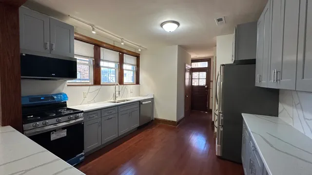 a kitchen with sink a microwave and cabinets