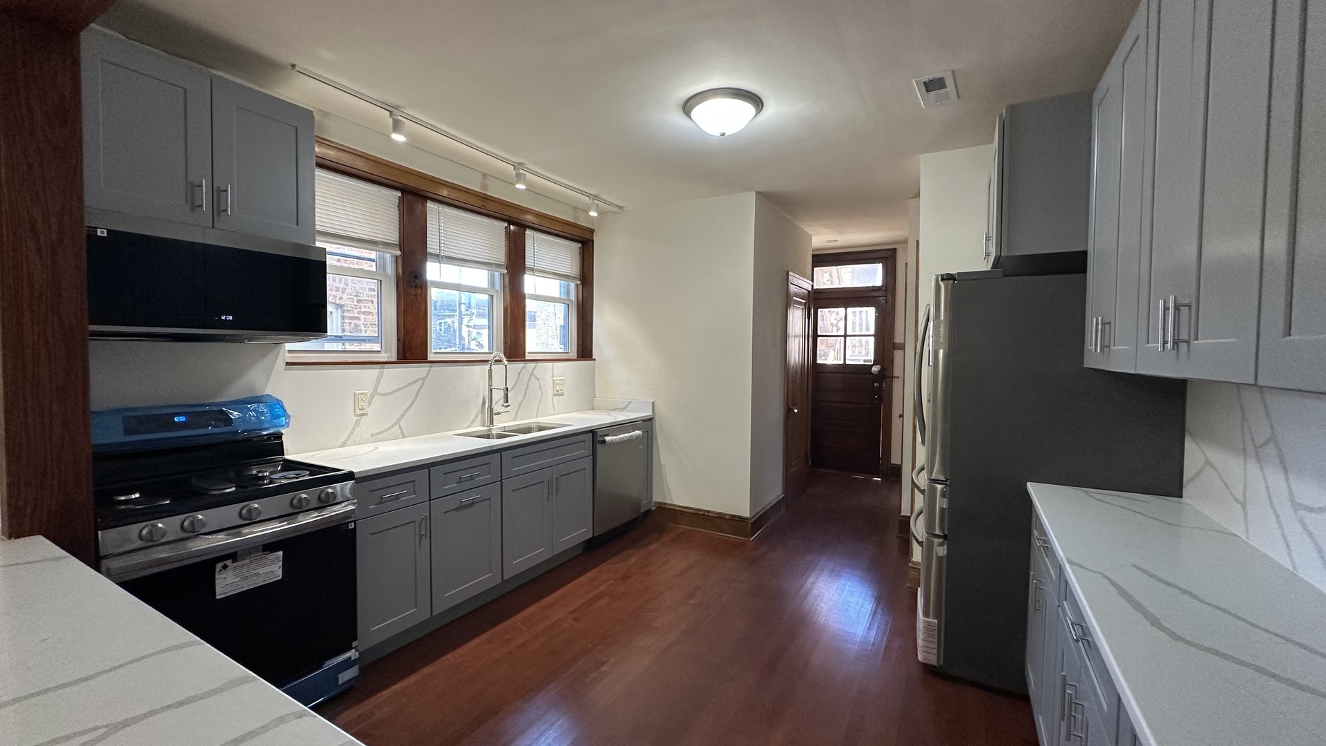 5530 North Artesian Avenue, Unit 3 Chicago, IL 60625 - Photo 13 of 16 a kitchen with sink a microwave and cabinets