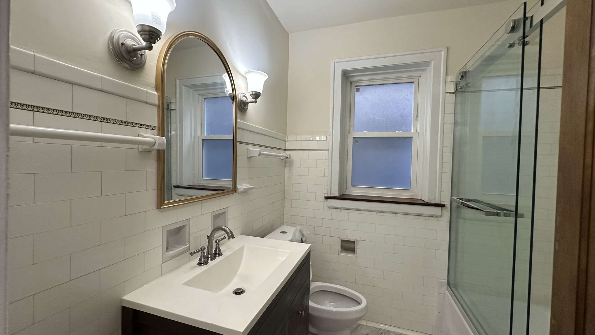 5530 North Artesian Avenue, Unit 3 Chicago, IL 60625 - Photo 7 of 16 a bathroom with a sink a toilet and shower