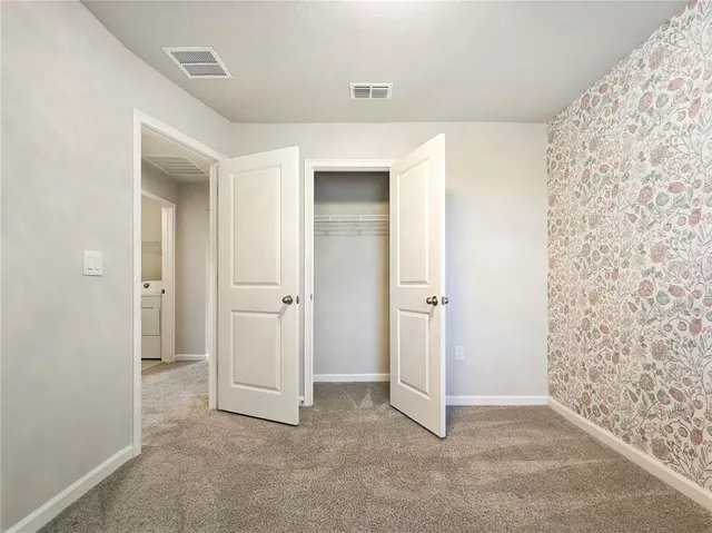 a bathroom with a sink toilet vanity and shower