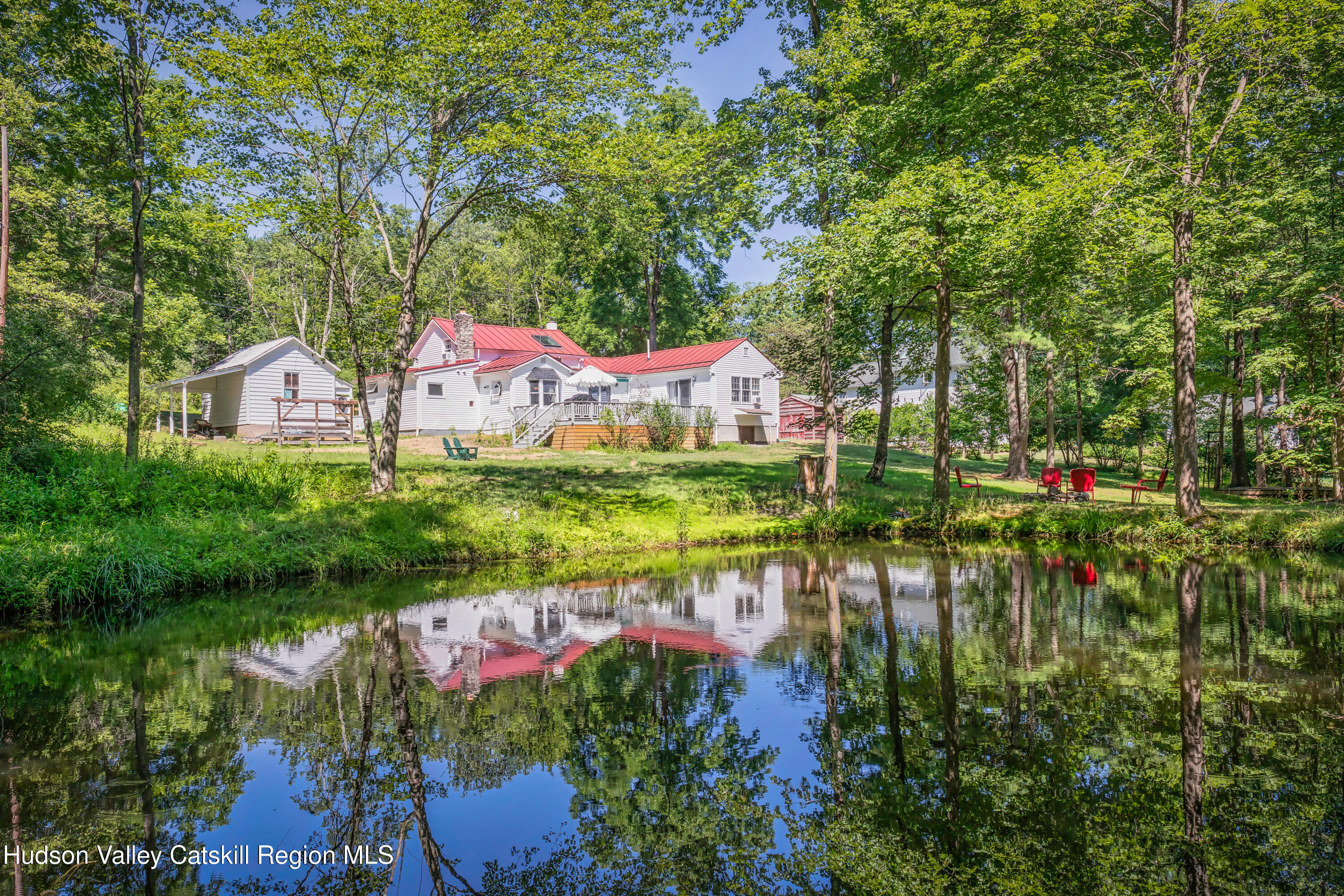 a view of a lake with a house in a yard
