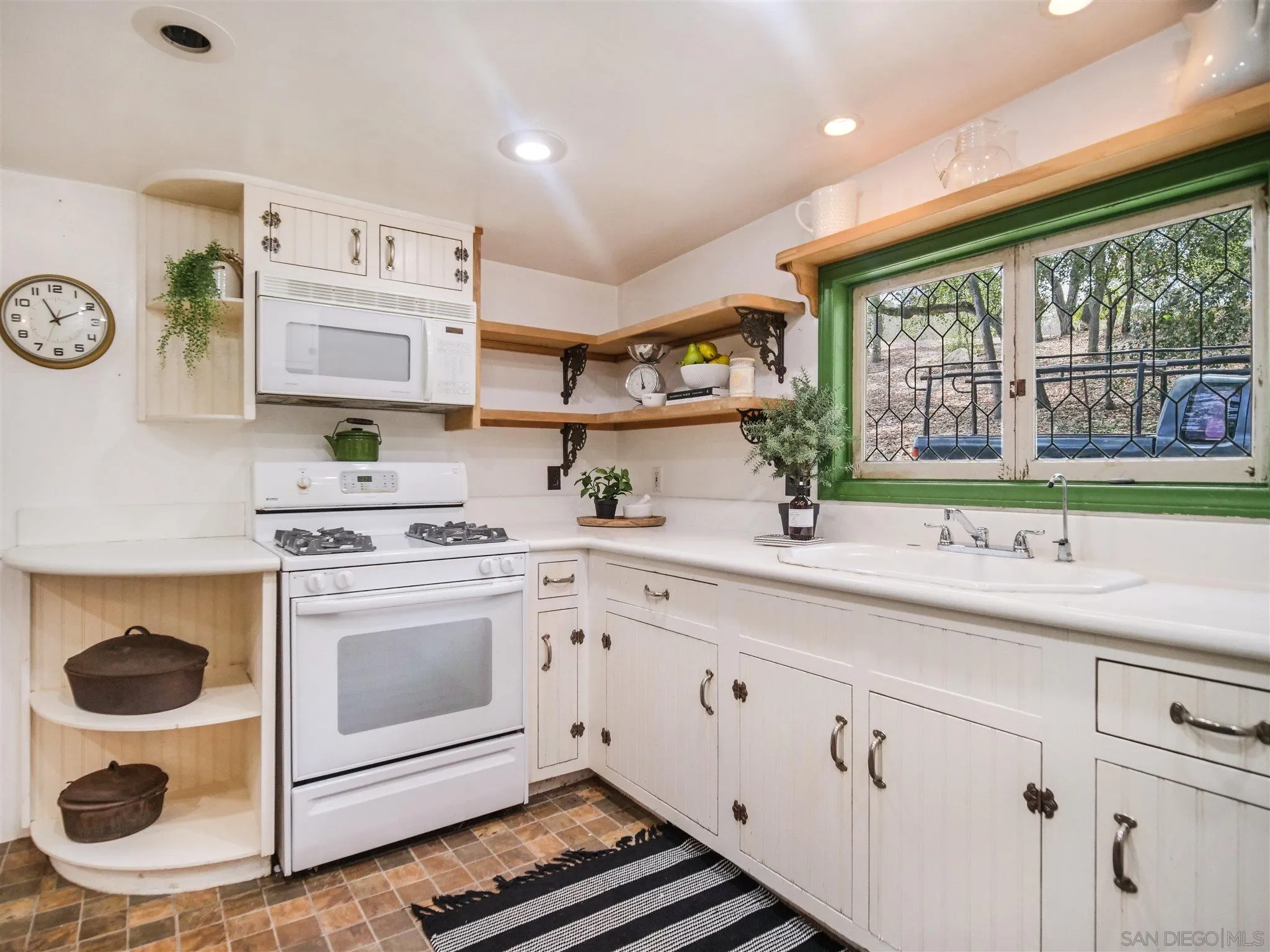 1102 Nicola Ranch Road Fallbrook, CA 92028 - Photo 30 of 63 a kitchen with a sink stove and cabinets