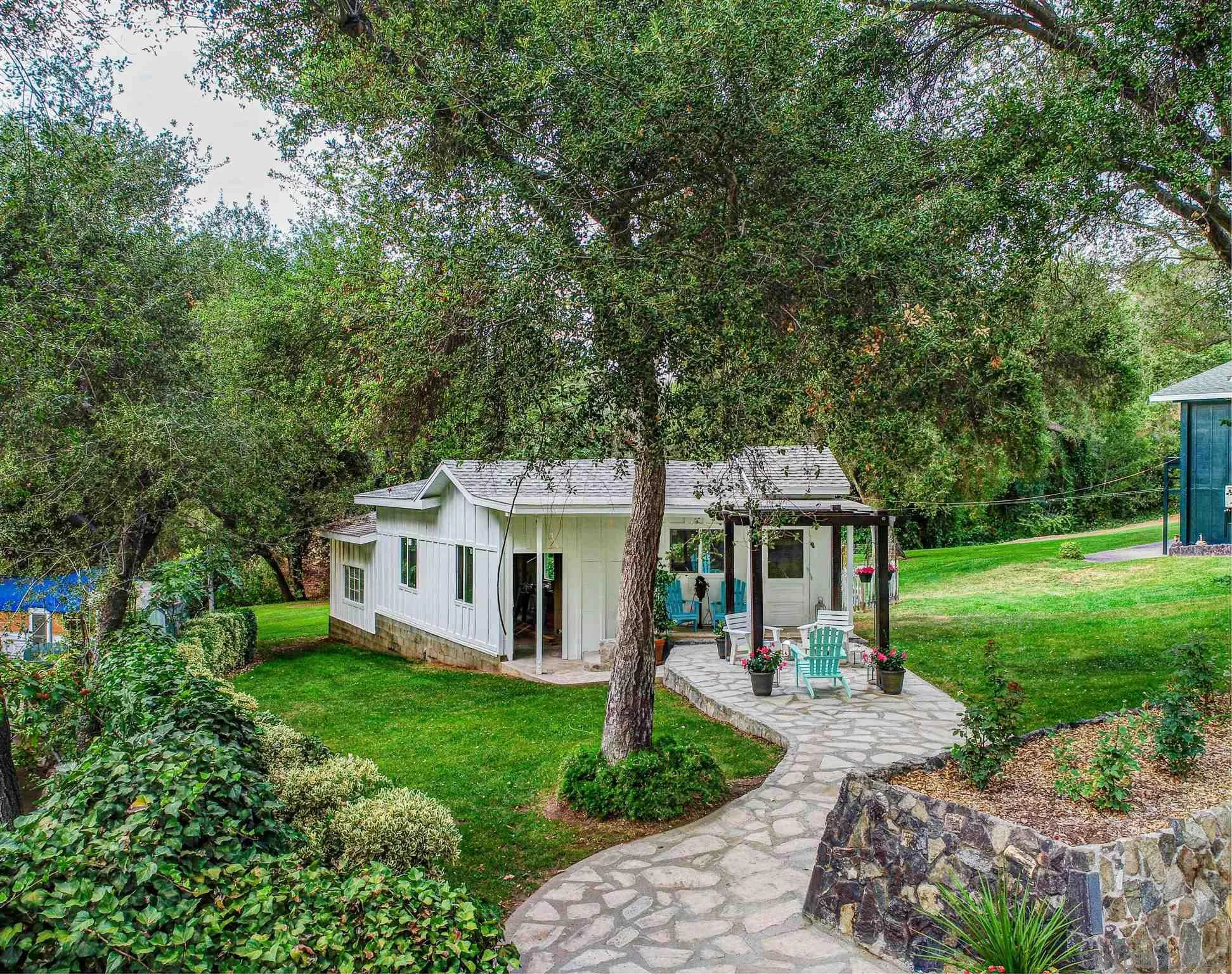 1102 Nicola Ranch Road Fallbrook, CA 92028 - Photo 4 of 63 a front view of a house with a yard and green space