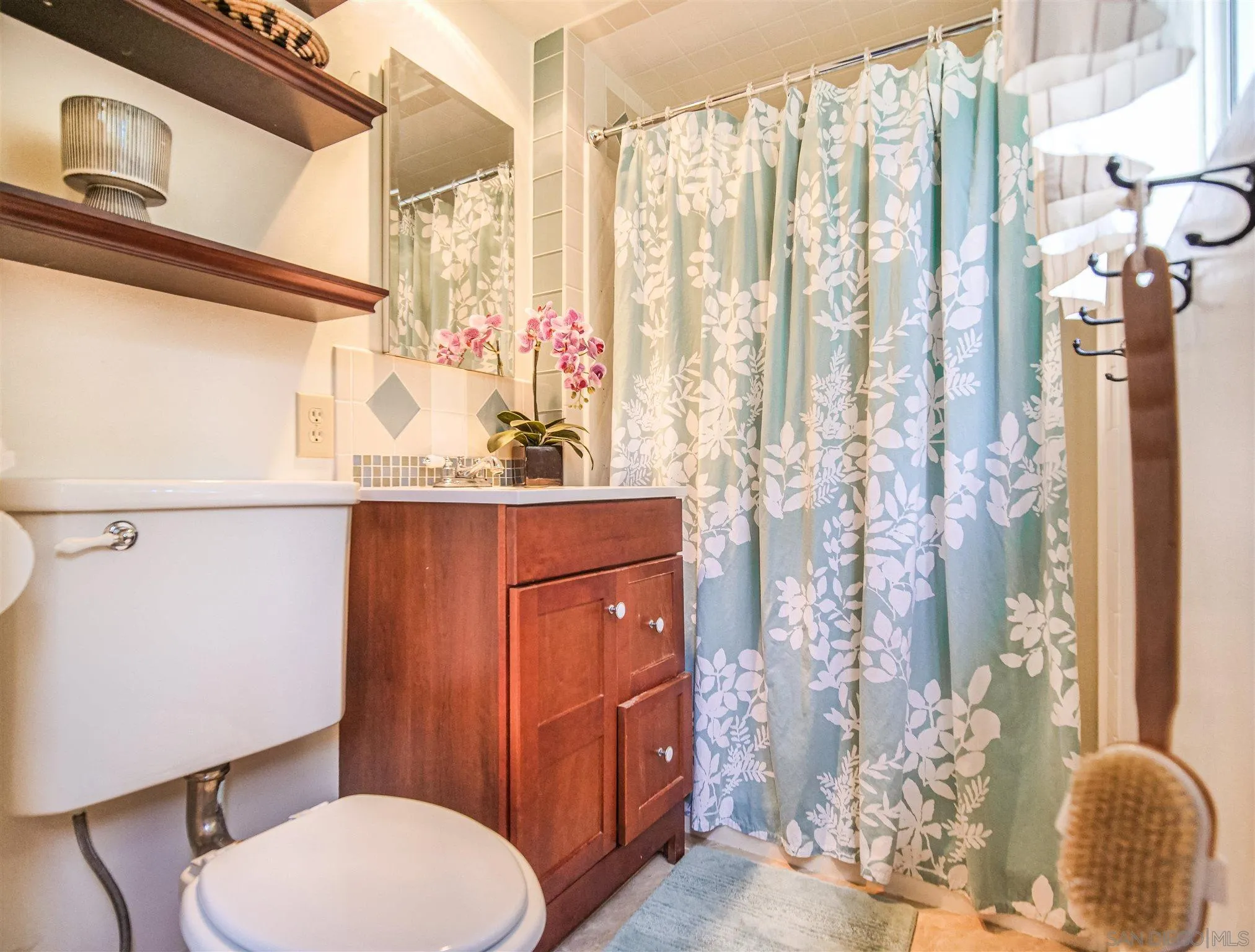 1102 Nicola Ranch Road Fallbrook, CA 92028 - Photo 41 of 63 a bathroom with a toilet a sink and curtain