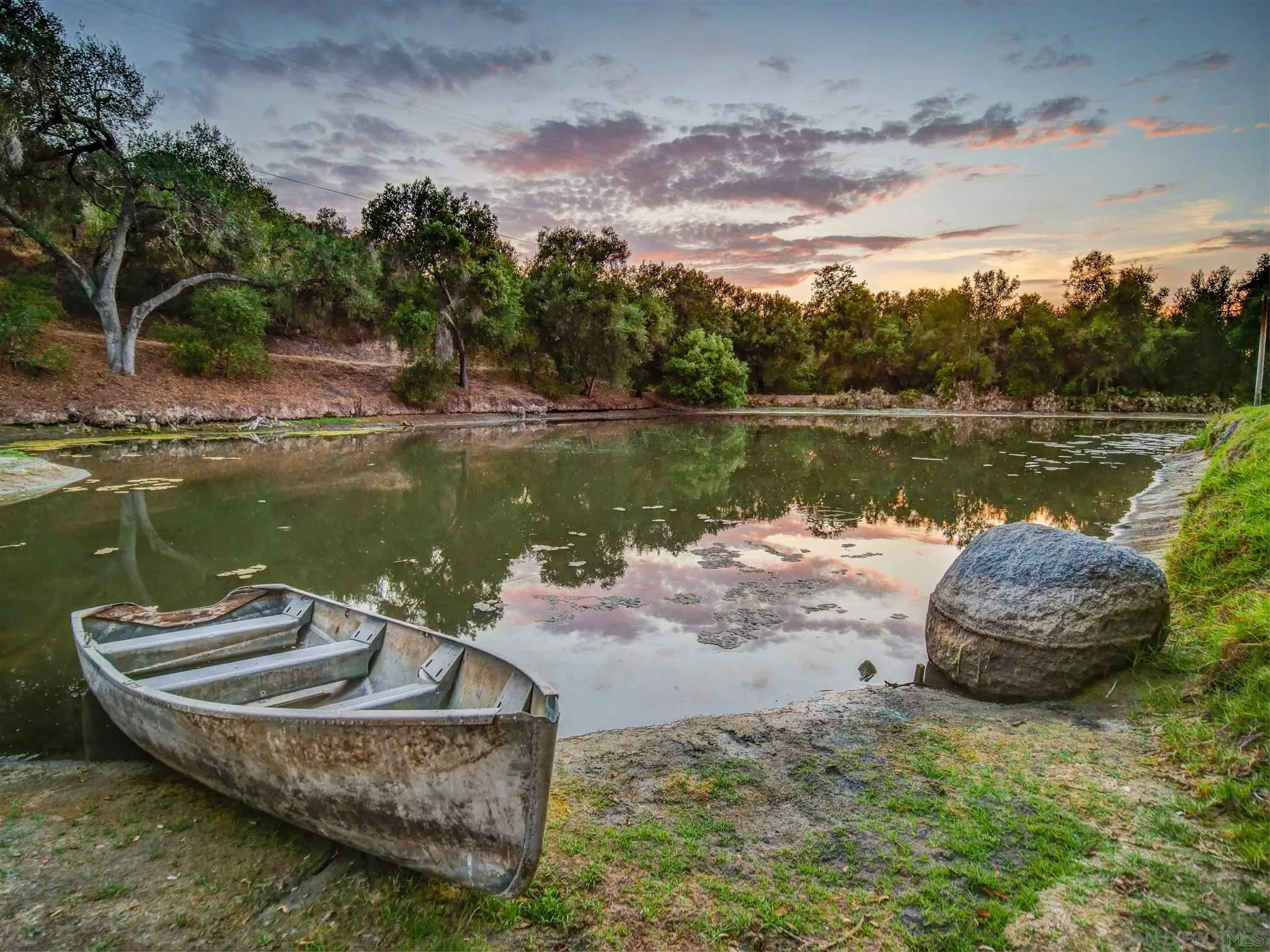 1102 Nicola Ranch Road Fallbrook, CA 92028 - Photo 51 of 63 a view of a lake with a yard and a fountain