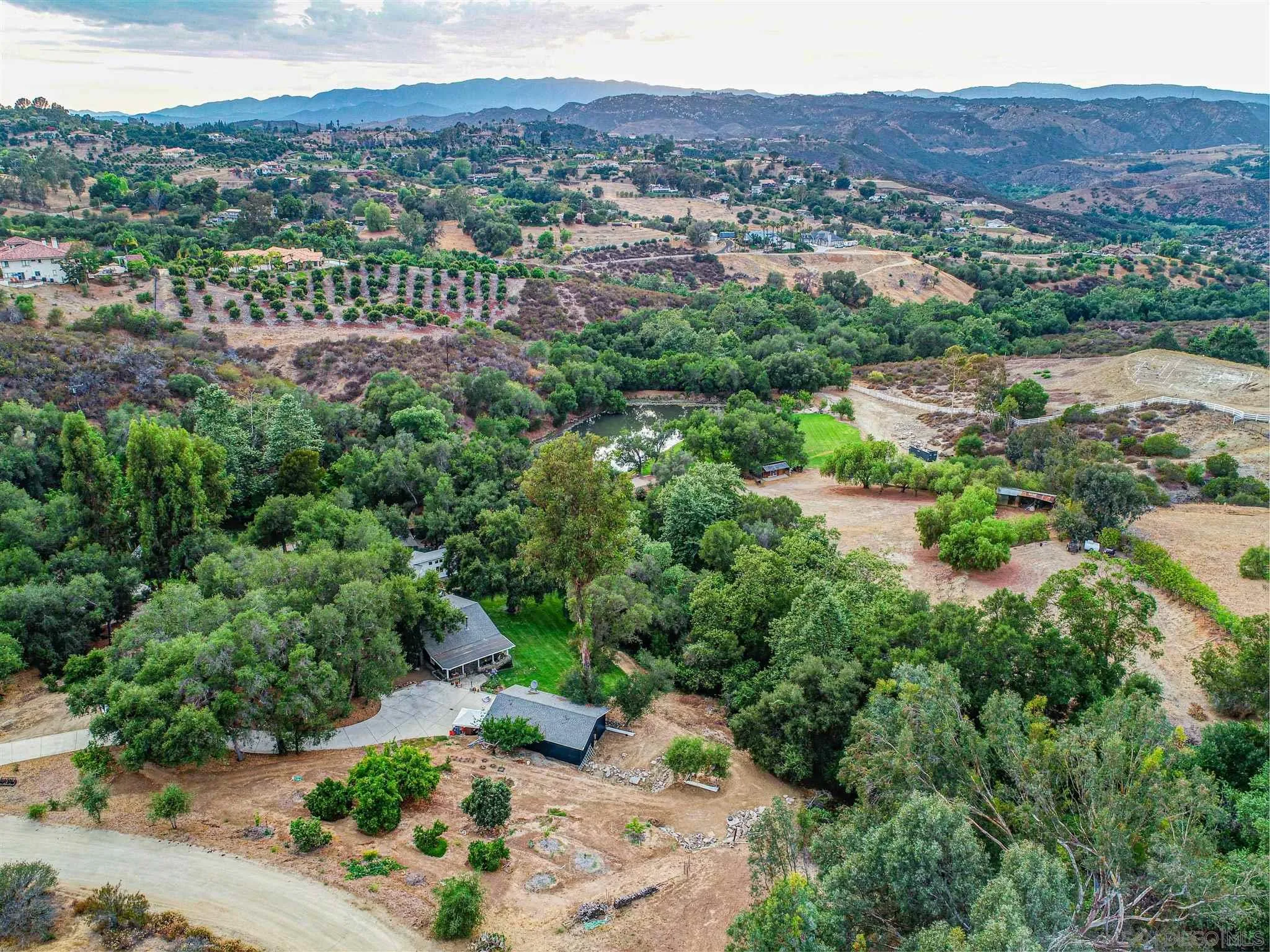 1102 Nicola Ranch Road Fallbrook, CA 92028 - Photo 59 of 63 a view of a lush green hillside and a houses