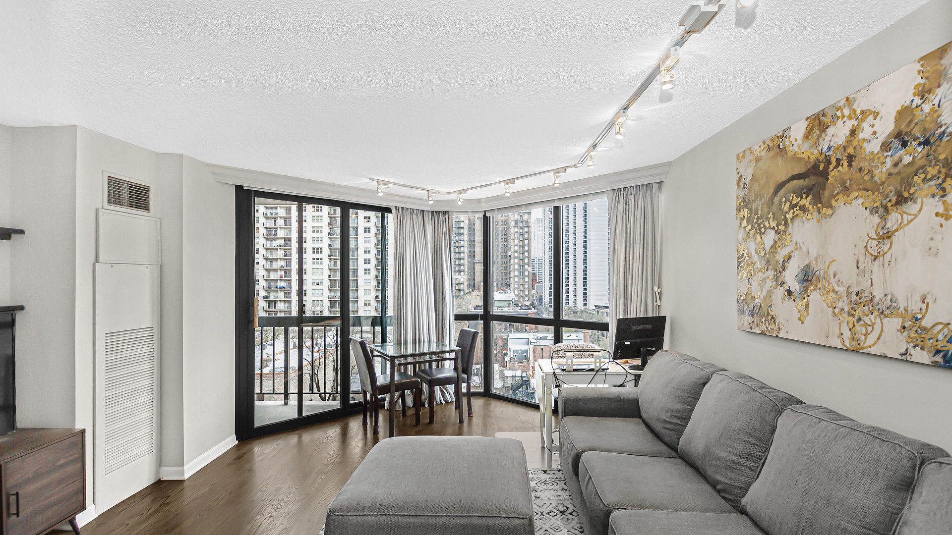 33 West Delaware Place, Unit 10G Chicago, IL 60610 - Photo 2 of 20 a living room with furniture and large windows