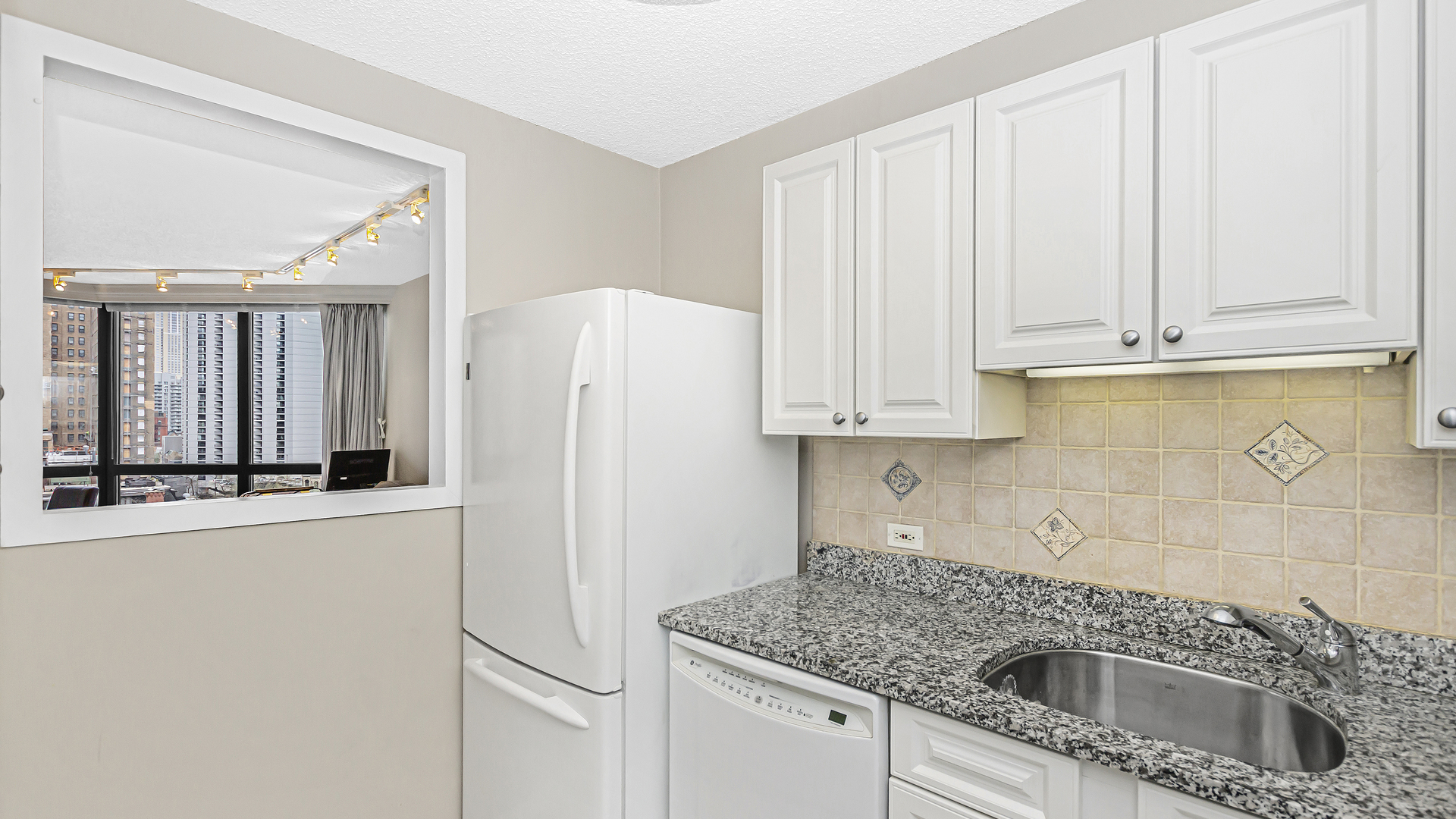 33 West Delaware Place, Unit 10G Chicago, IL 60610 - Photo 7 of 20 a kitchen with stainless steel appliances granite countertop a refrigerator sink and cabinets