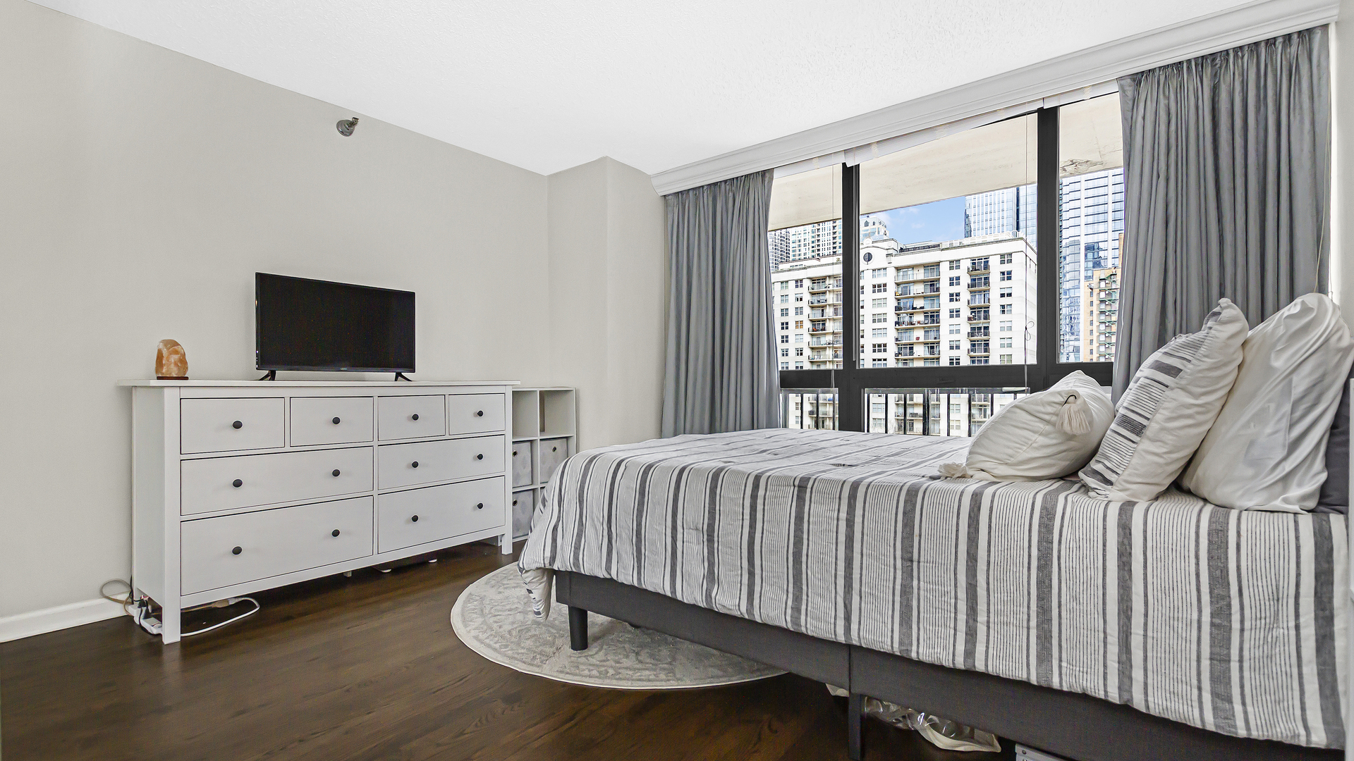 33 West Delaware Place, Unit 10G Chicago, IL 60610 - Photo 9 of 20 a bedroom with a bed and flat screen tv