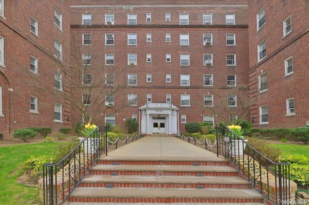 175-06 Devonshire Road, Unit 4M Queens, NY 11432 - Photo 17 of 18 a view of a building with a yard