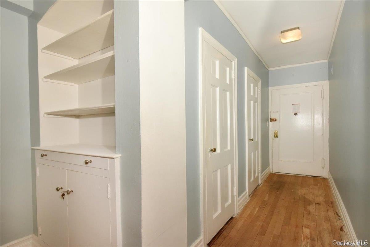 175-06 Devonshire Road, Unit 4M Queens, NY 11432 - Photo 2 of 18 a view of a hallway with wooden floor and closet