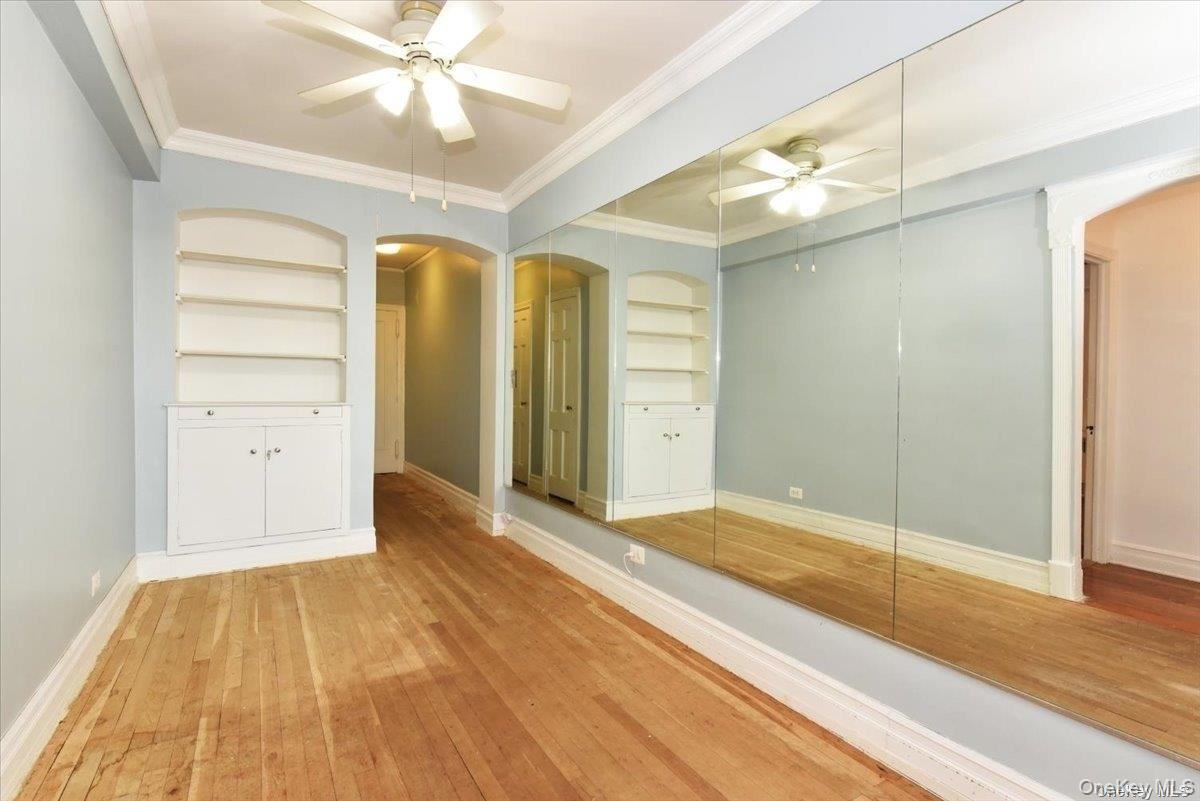 175-06 Devonshire Road, Unit 4M Queens, NY 11432 - Photo 6 of 18 a view of a room with wooden floor and closet area