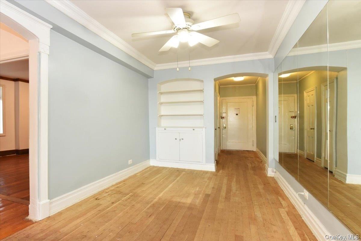 175-06 Devonshire Road, Unit 4M Queens, NY 11432 - Photo 7 of 18 a view of a room with wooden floor and door