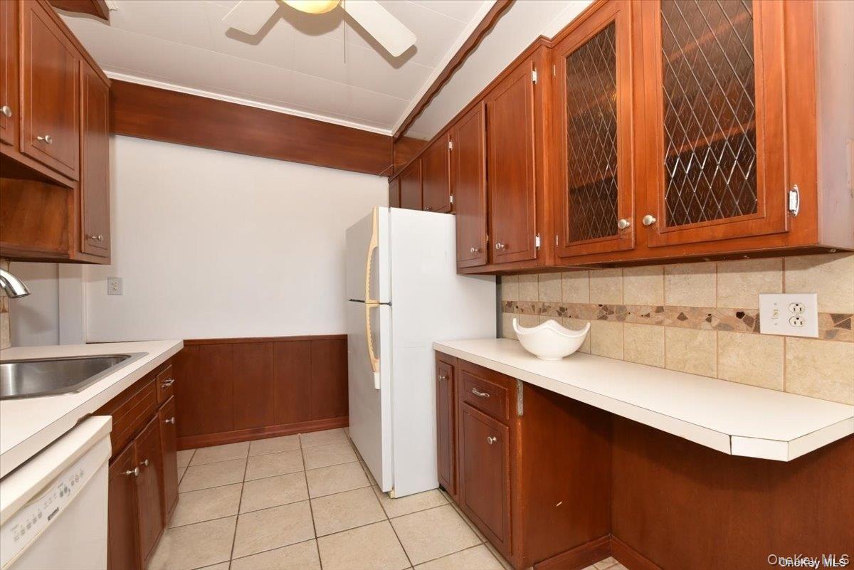 175-06 Devonshire Road, Unit 4M Queens, NY 11432 - Photo 9 of 18 a kitchen with stainless steel appliances a sink a refrigerator and a stove