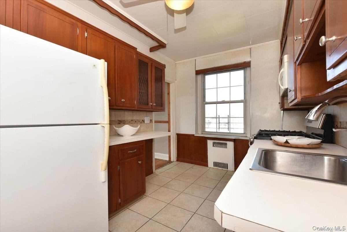 175-06 Devonshire Road, Unit 4M Queens, NY 11432 - Photo 10 of 18 a kitchen with a refrigerator sink and stove