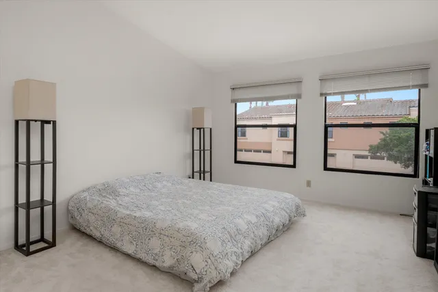 a living room with furniture a flat screen tv and a large window