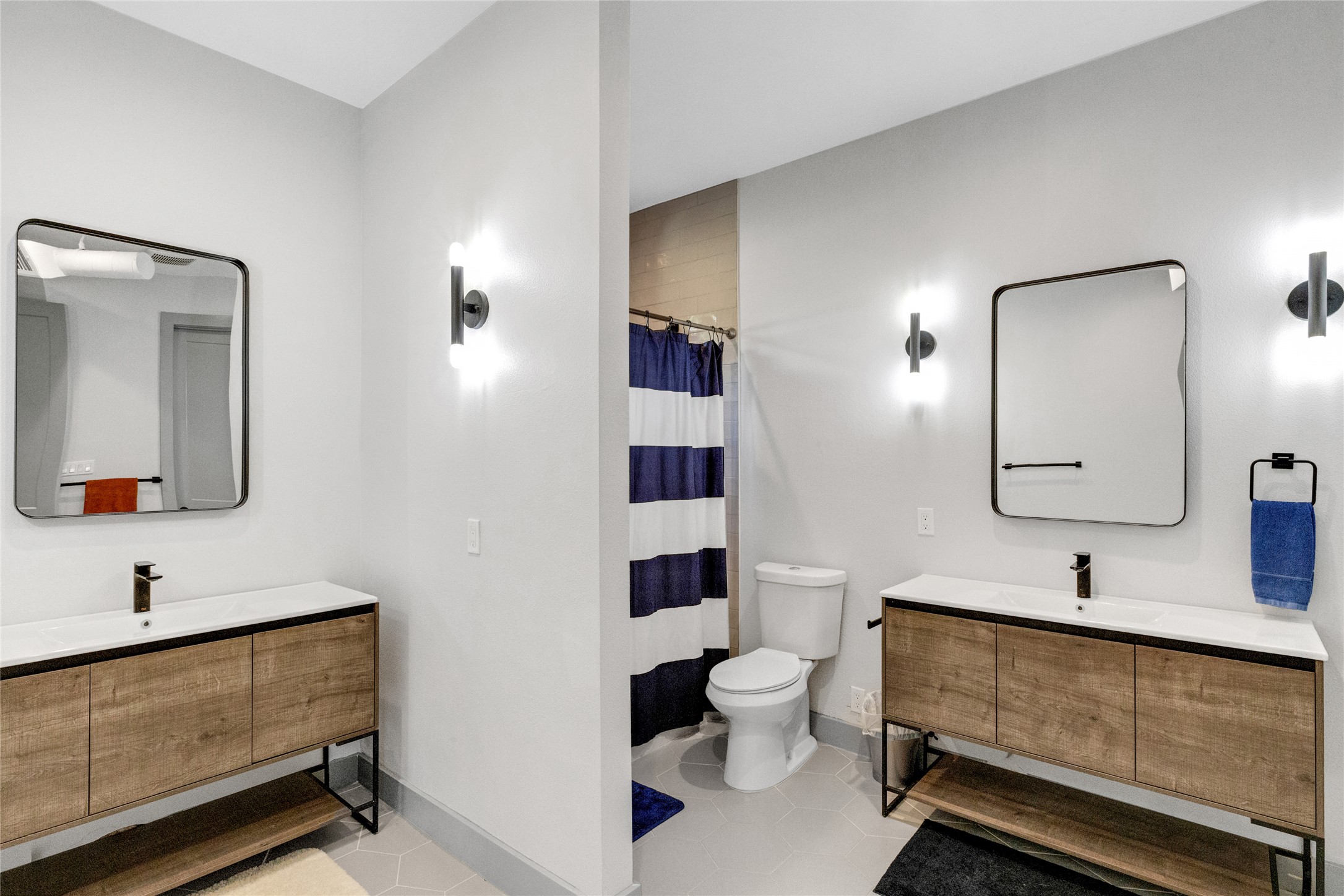 4227 Eck Lane Austin, TX 78734 - Photo 24 of 30 Bathroom featuring vanity, curtained shower, and light tile patterned flooring